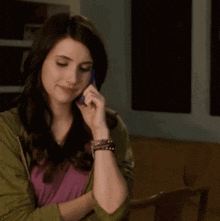a woman talking on a purple cell phone