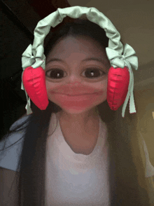 a girl wearing a headband with a carrot on it