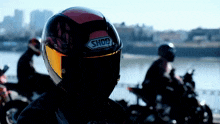 a person wearing a shoe helmet stands in front of a river