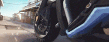 a close up of the front wheel of a motorcycle on a city street .
