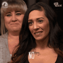 a woman with a tattoo on her chest is smiling and says no