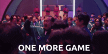 a group of people standing in a room with the words `` one more game '' written on the bottom .