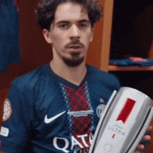 a man holding a trophy that says ultra on it