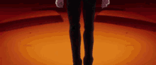 a close up of a person 's legs standing on a stage in a dark room .