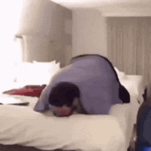 a man is laying on his stomach on a bed .