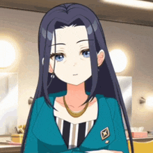 a woman with long dark hair and blue eyes is wearing a blue jacket and striped shirt