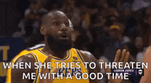 a basketball player in a yellow jersey is talking to another player during a game .