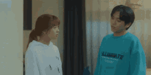 a man wearing a blue shirt that says illuminate