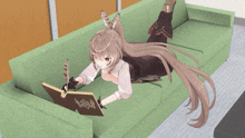 a girl with long hair is laying on a green couch reading a book