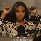 a woman in a floral shirt stands in front of a microphone and says tristanjr ( commandercodybest )