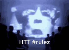a group of people standing in front of a screen that says htt #rolez