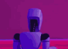 a purple robot is standing in front of a pink background in a room .