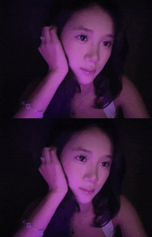 a woman 's face is shown in a purple light and in a dark room
