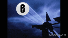 a silhouette of a man standing on top of a building with the number 6 in a white circle