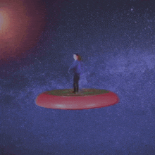 a man in a purple shirt is standing on a frisbee
