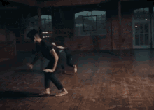 a group of people are dancing in a dark room in front of a drummer .