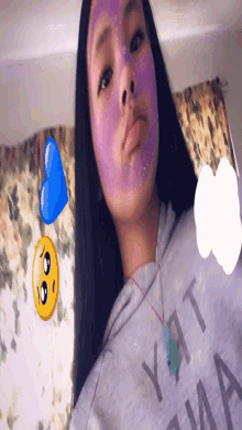 a girl with a purple mask on her face and a sad face
