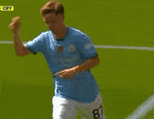 a soccer player giving a high five to a referee on the field
