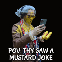 a man with mustard on his face looks at his phone