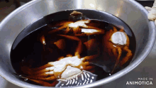 crabs are being cooked in a bowl with the words made in animotica visible