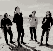 a black and white photo of four men with the words wordsoverpictures at the top