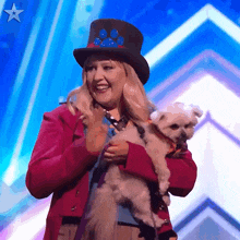 a woman wearing a top hat is holding a small white dog