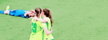 a group of female soccer players wearing green jerseys with the number 29 on them
