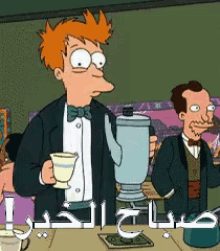 a man in a tuxedo is holding a cup and a blender in front of a sign that says صباح الخير