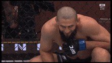 a man wearing a pair of ufc gloves looks down