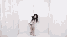 a woman with a nose ring is singing into a microphone in a dark room .