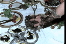 a woman 's hand is reaching into a tray of grapes