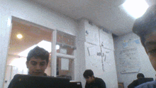 a group of people are sitting in front of a wall that says world