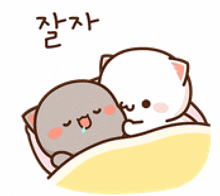 a couple of cats laying on top of each other with a heart above them