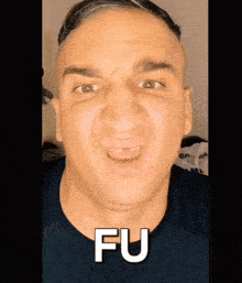 a close up of a man 's face with the word fu written on it