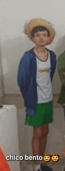 a young man wearing a cowboy hat and green shorts is standing in a bathroom with other people .