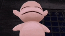 a pink stuffed animal with a sad face is standing in front of a door .