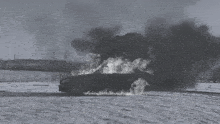 a car is on fire in the snow and smoke is coming out of it