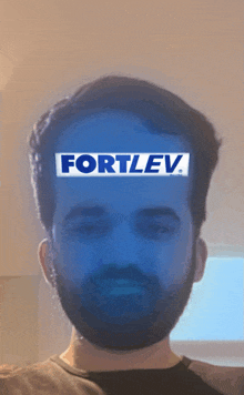a man with a fortlev sticker on his head