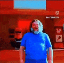 a man in a blue shirt is standing in front of a mixer in a restaurant .