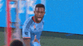 a man in a blue adidas jersey is giving a high five