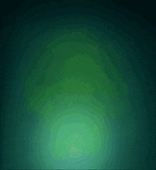 a green background with a yellow object in the center