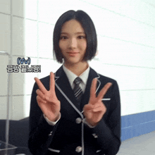 a girl in a school uniform is giving the peace sign