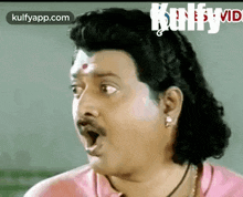 a man with a mustache and long hair is making a funny face with his mouth open .