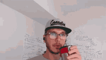 a man drinking from a stainless steel bottle with the word bizness rebels written on the bottom