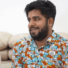 a man with a beard is wearing a shirt with license plates including jk 008