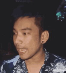 a man is making a funny face with his tongue sticking out .