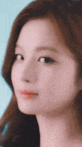 a close up of a woman 's face with a blurry background