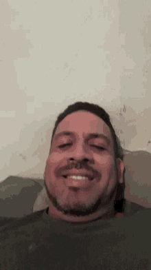 a man with his eyes closed and a green shirt on