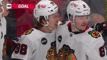 two hockey players wearing helmets that say belle tire on them