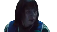 a woman with short hair and a blue and green jacket